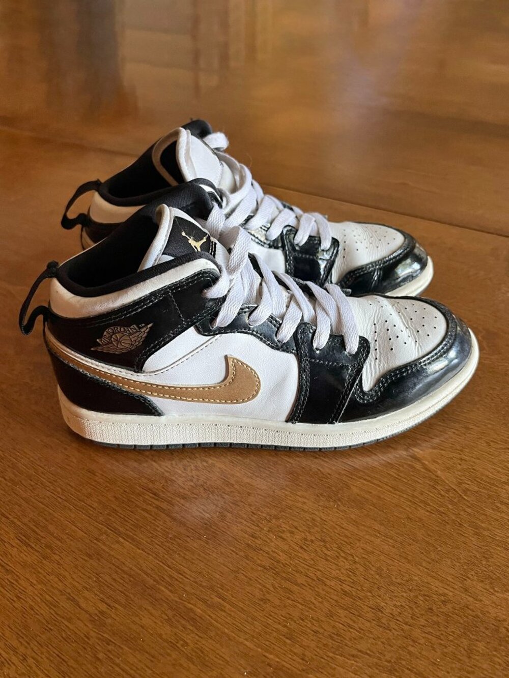 Nike Jordan 1 Mid sneakers in patent black and gold 3Y